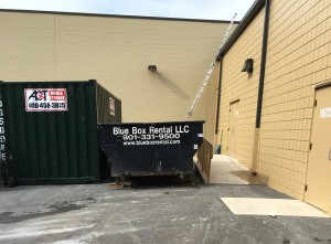 Blue Box Rentals rented dumpster in a tight spot on a commercial job site
