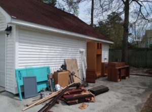 Junk next to Garage to go in a rental dumpster from Blue Box Rental